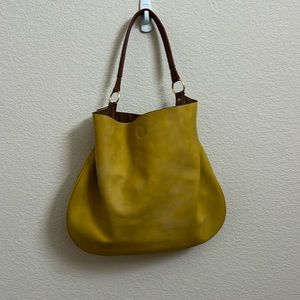 Yellow shoulder bag with cosmetics bag